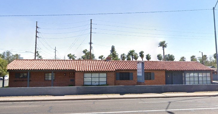 a red brick building on the side of a street