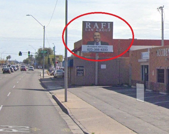 a sign on the side of a building on a city street