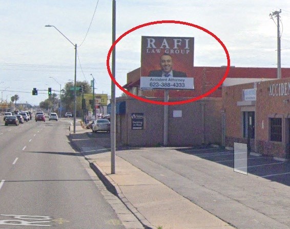 a sign on the side of a building on a city street