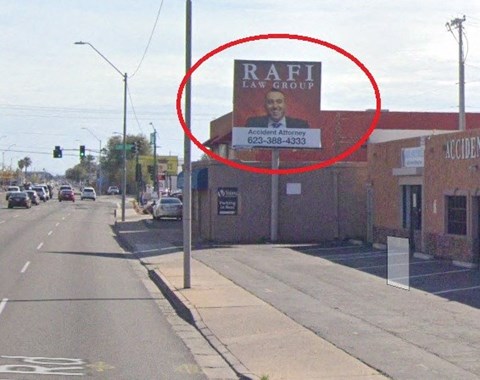 a sign on the side of a building on a city street