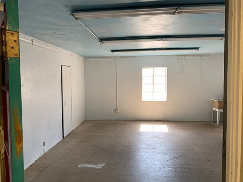 an empty room with a window and a door