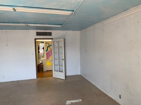 an empty room with a door to a hallway