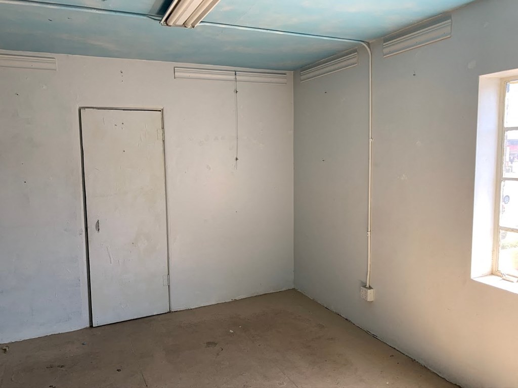 a room with white walls and a door