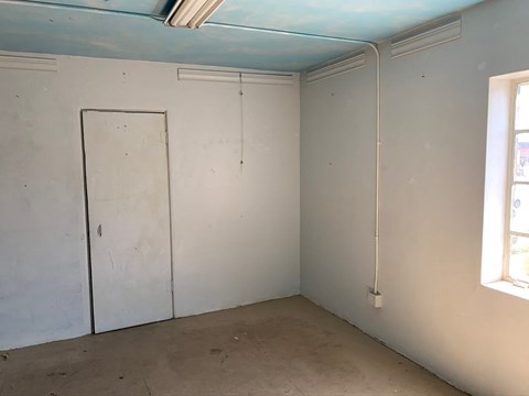 a room with white walls and a door