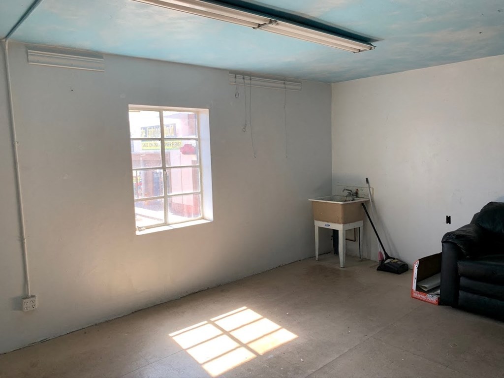 an empty room with a desk and a window