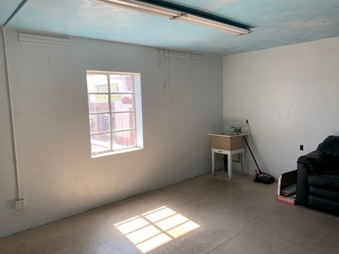 an empty room with a desk and a window