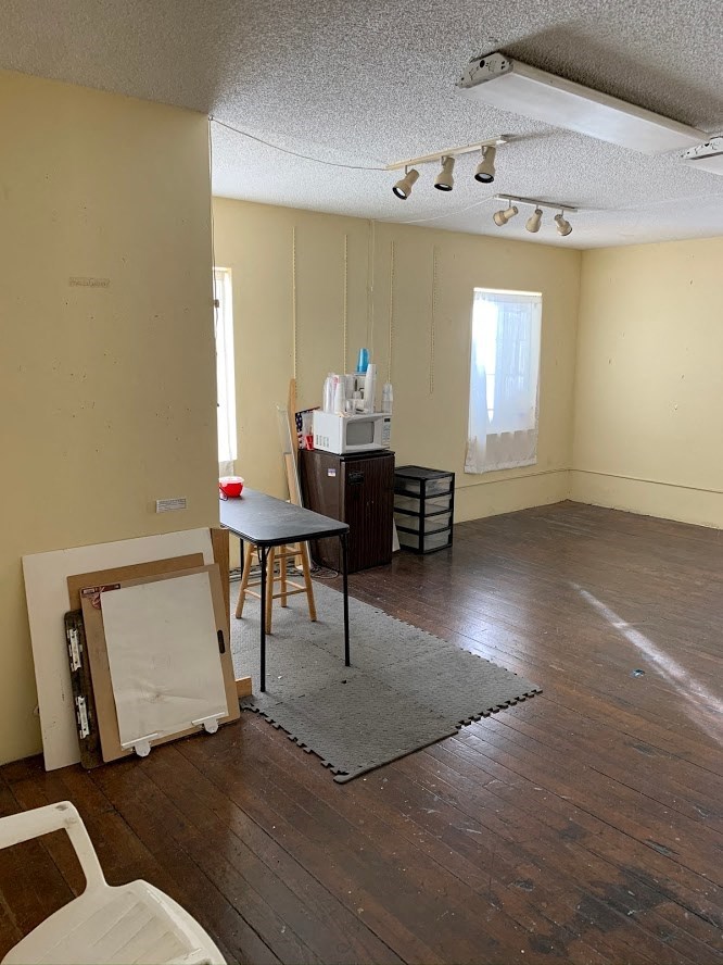 an empty room with a desk and a table in it