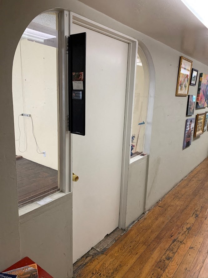 a hallway with an open door and a mirror