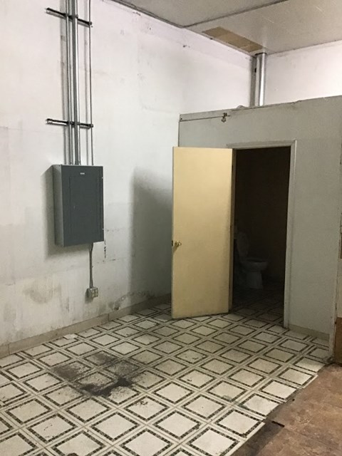 a bathroom with a door and a toilet in it