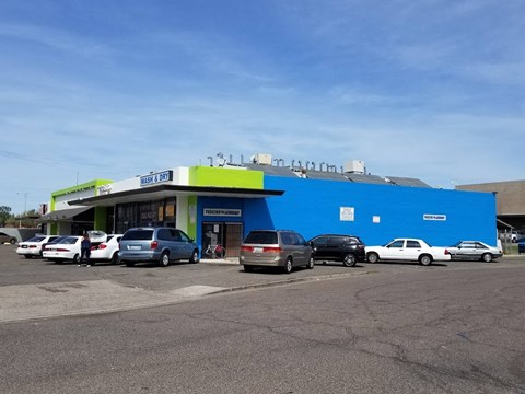 a blue building with cars parked in front of it