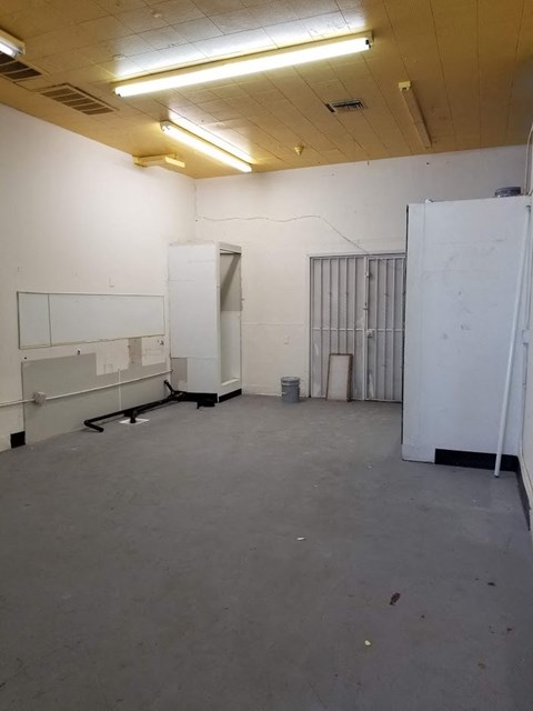 an empty room with two white cabinets in it