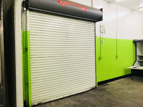 a garage door with a green and white wall behind it