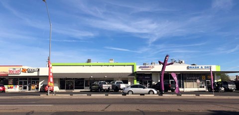 the front of a gas station with cars parked in front of it