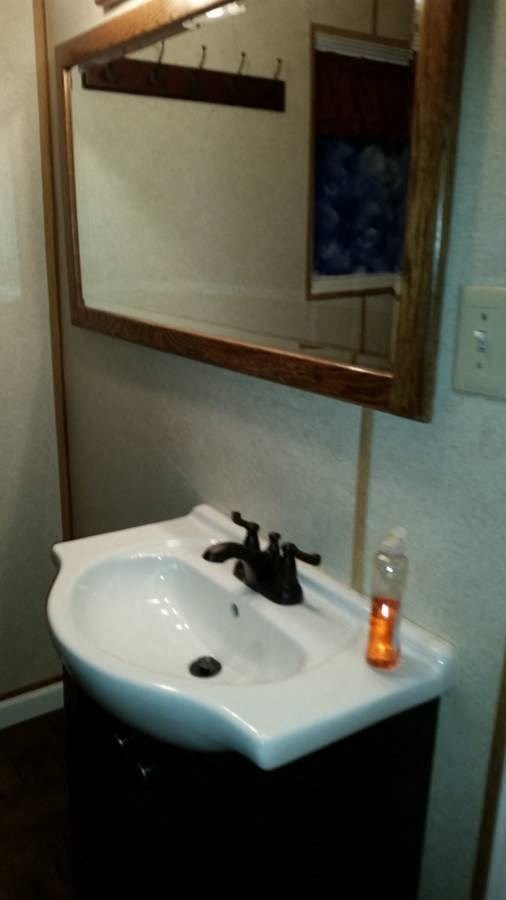 a white sink in a bathroom with a mirror