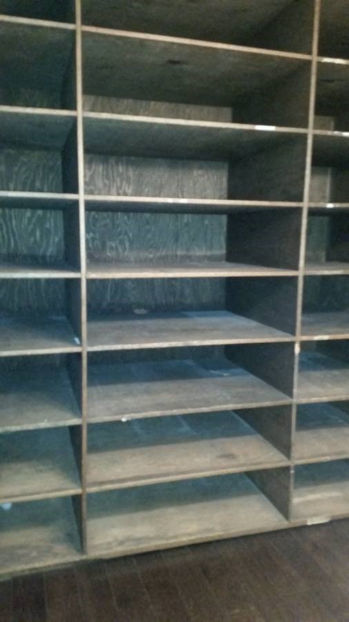 a book shelf with many empty shelves on it