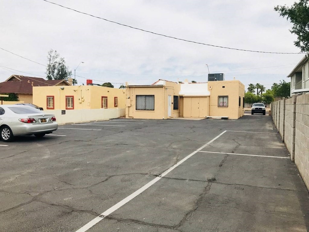 an empty parking lot in front of a building
