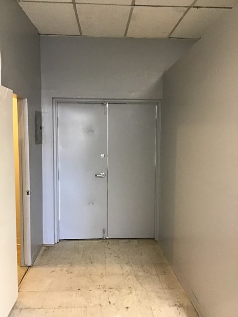 a hallway with a closet and a door