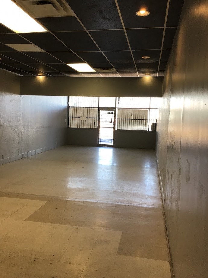a large empty room with a door in the middle