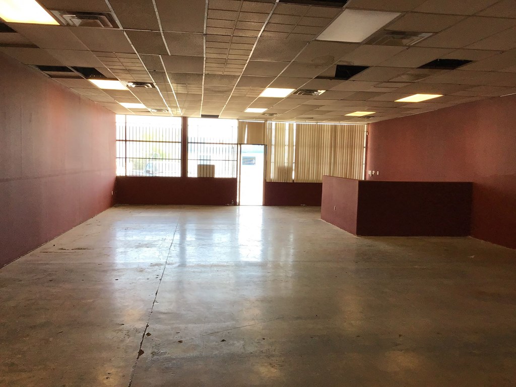 an empty room with a concrete floor and a window