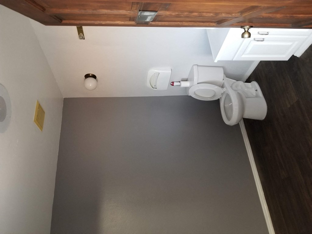 a bathroom with a urinal and a toilet in it