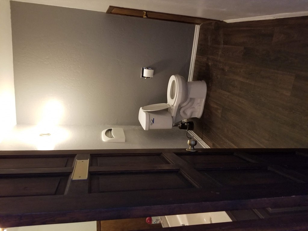 a bathroom with a urinal and a toilet in it