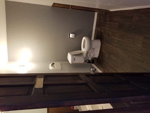 a bathroom with a urinal and a toilet in it
