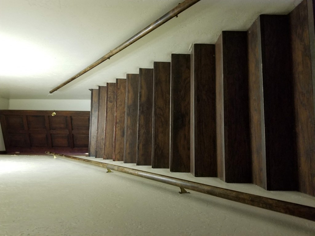 an empty room with wooden walls and a white floor