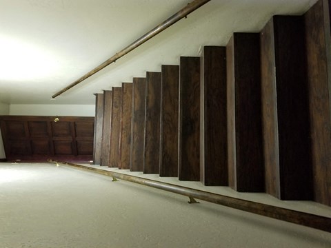 an empty room with wooden walls and a white floor