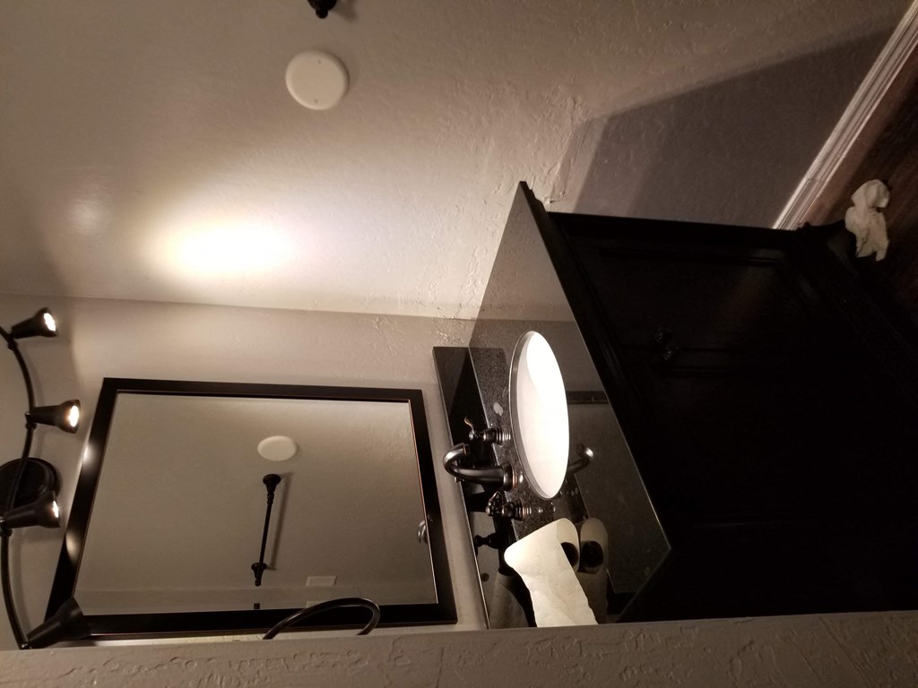 a bathroom with a mirror and a toilet in it