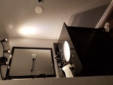 a bathroom with a mirror and a toilet in it