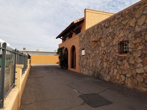 a building with a stone wall and a gate
