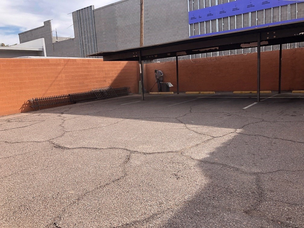 a person walking down a brick wall in front of a building