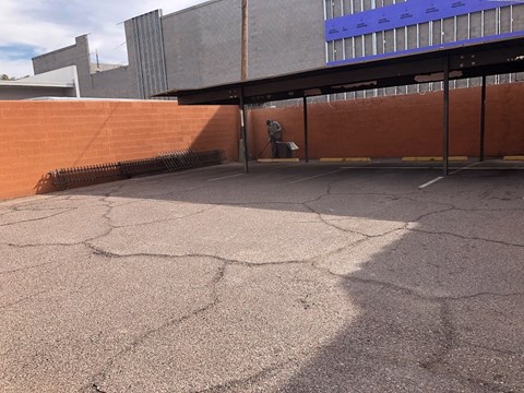 a person walking down a brick wall in front of a building