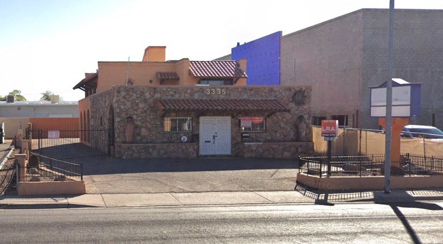 a small brick building on the side of a street