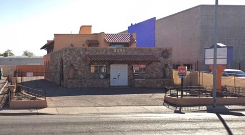 a small brick building on the side of a street