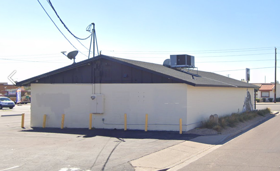 a white building with an air conditioning unit on the roof