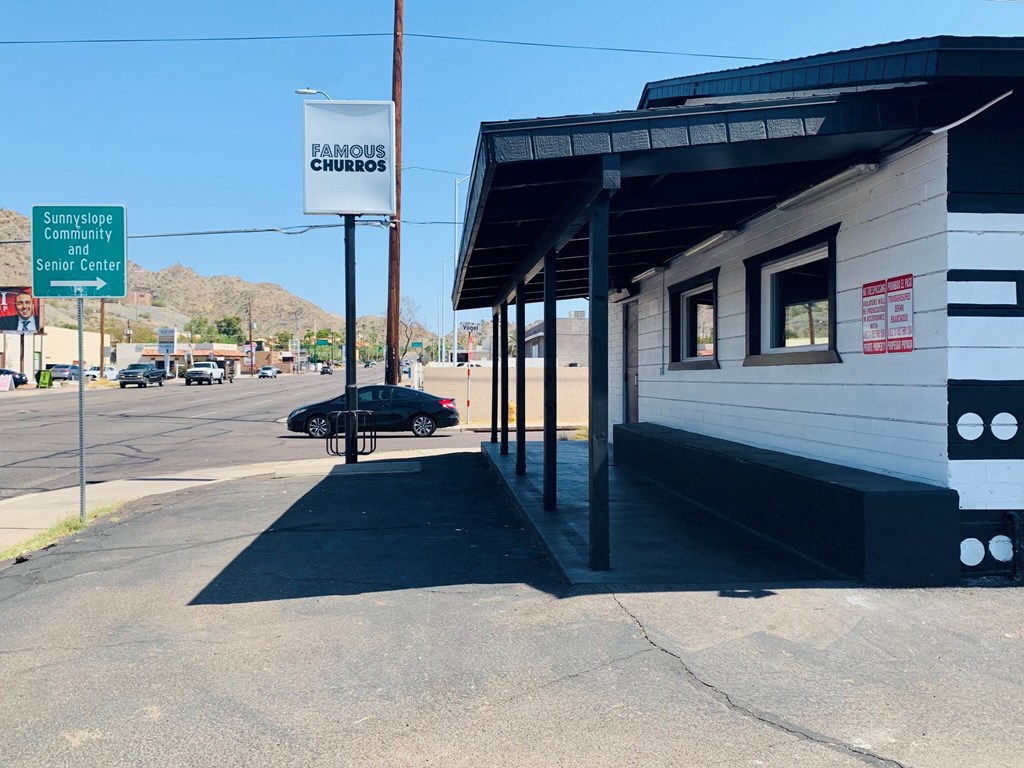 a white building with a black car parked in front of it