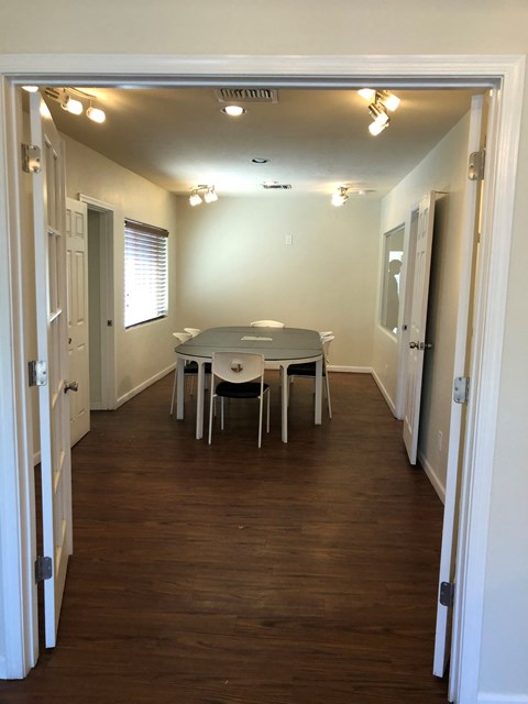 a view of a dining room with a table and chairs