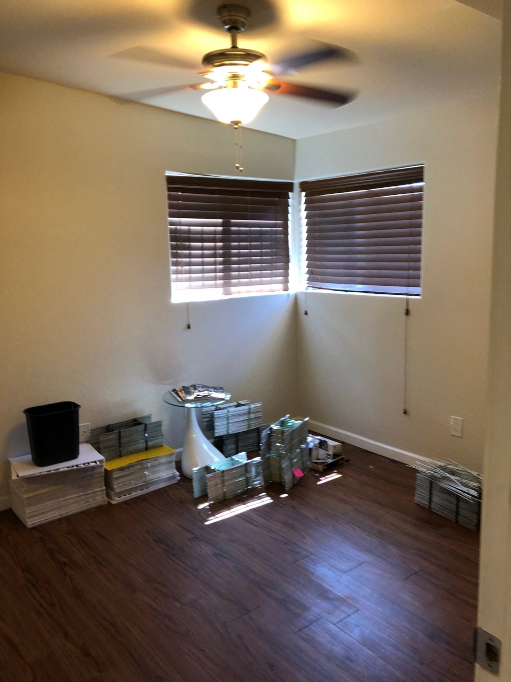 the living room is being remodeled with wood floors and a ceiling fan