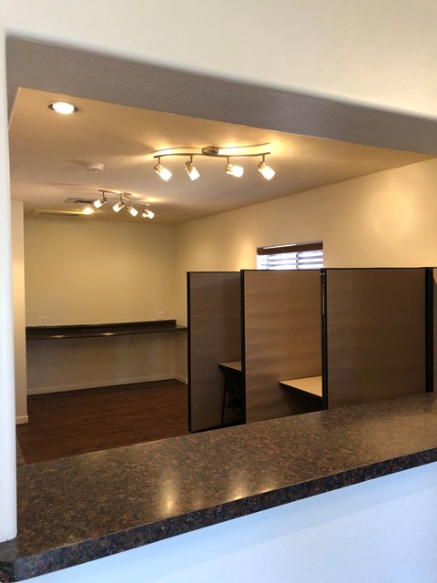 an empty room with wooden dividers and lights on the ceiling