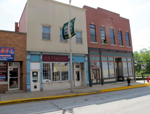A building with a green flag on a pole in front of it.