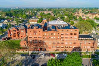 an aerial view of a large brick building in the city