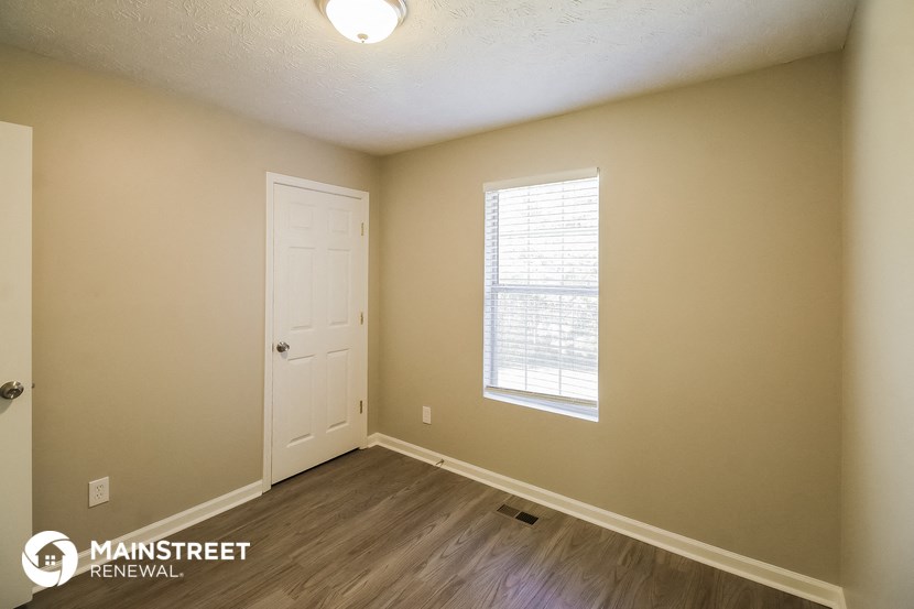 the interior of an empty room with a door and a window