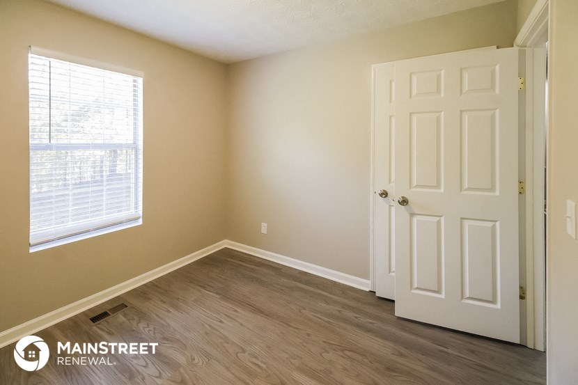 the interior of an empty room with a door and a window