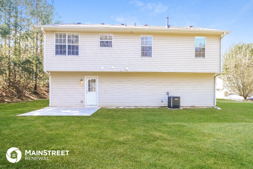 a white house with a lawn in front of it