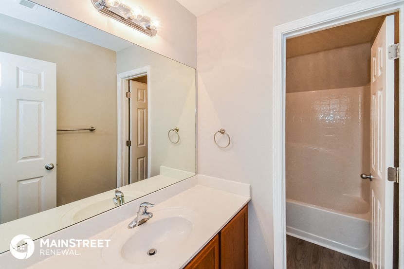 a bathroom with a sink and a mirror and a shower