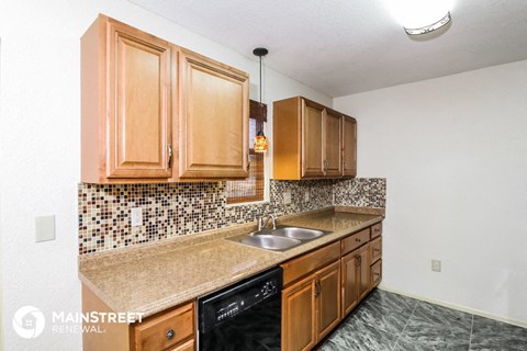 a kitchen with wooden cabinets and a sink