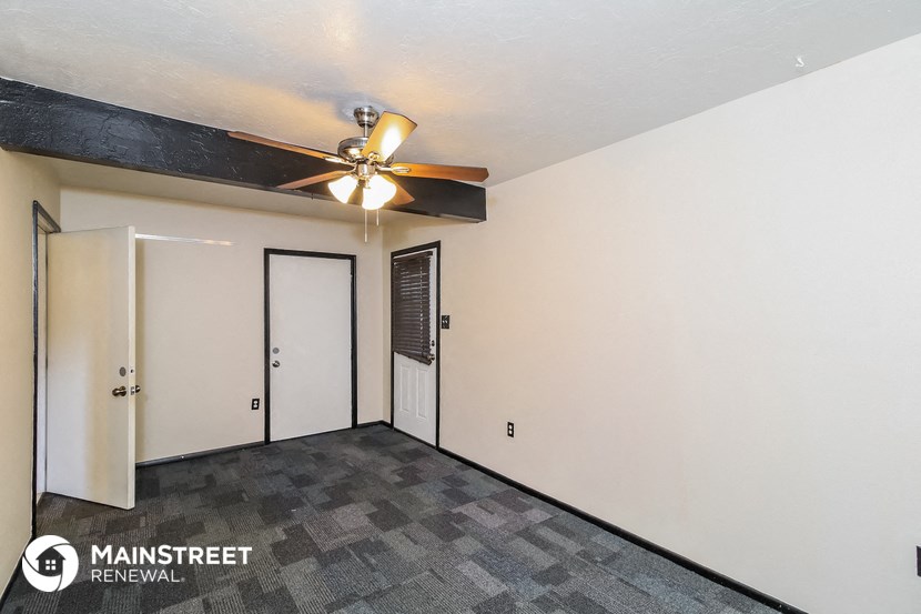 the living room of a home with a ceiling fan
