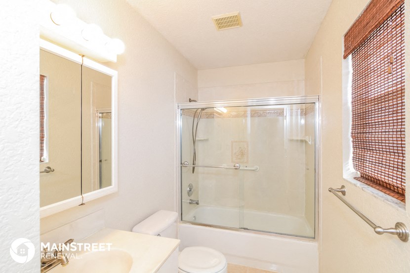 a bathroom with a shower and a sink and a mirror