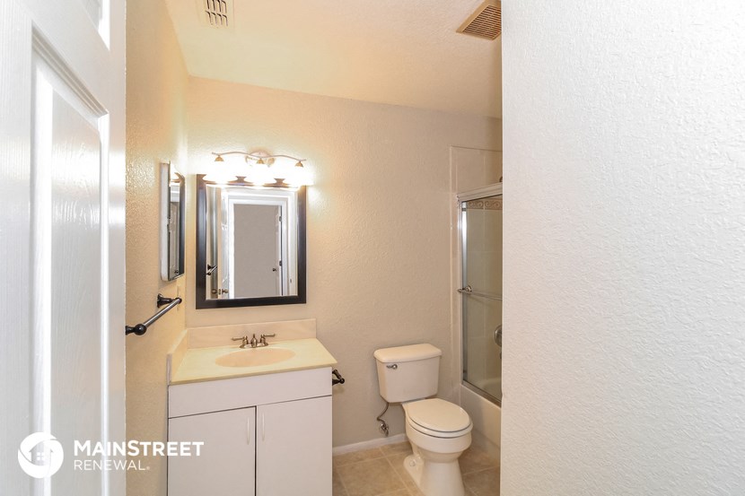 a bathroom with a sink toilet and a mirror